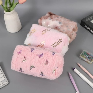 Flat lay of colorful plush pencil cases with star, butterfly, and unicorn embroidery