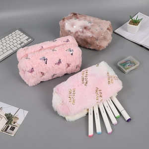 Detailed view of plush stationery bags with cute star and floral prints on a gray desk