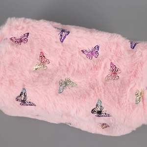 Detail of pink faux fur pencil case with colorful metallic foil butterfly patterns