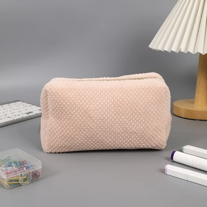 Detail of waffle textured plush pencil case in cream pink with zipper closure