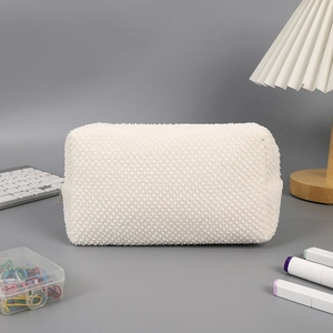Detailed view of white waffle textured pencil case with soft fabric and zipper closure