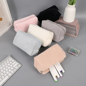 Close-up of high-capacity corduroy pencil cases in six assorted muted pastel colors