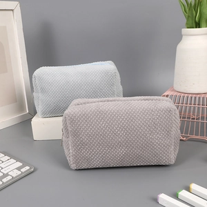 Close-up of blue and grey waffle texture plush pencil cases on a tidy desk setup