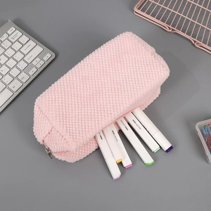 Pink plush pencil case with textured fabric and colorful highlighters inside