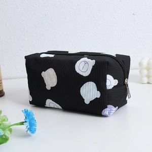 Detail of black corduroy makeup bag with cute gummy bear print and silver metal zipper