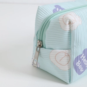 Detail of light blue corduroy fabric with cute bear print and sturdy metal zipper