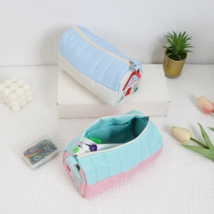 Quilted fabric stationery case with embroidery and multiple internal storage pockets