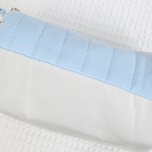 Close-up of blue and white quilted pencil case showing stitching detail and zipper