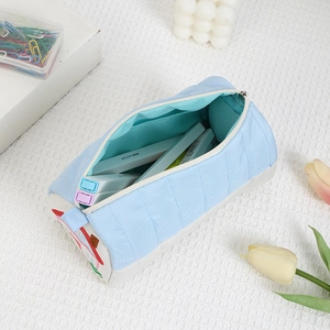 Close-up of a blue quilted house-themed stationery bag showing a large storage capacity