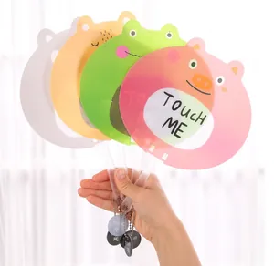 Close-up of four cute cartoon animal hand fans with transparent handles and bead charms