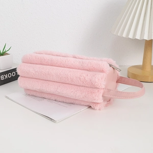 Pink plush large capacity pencil case with quilted texture and PU handle on desk
