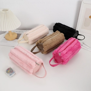Detail of five colorful plush pencil cases with soft faux fur texture and hand straps