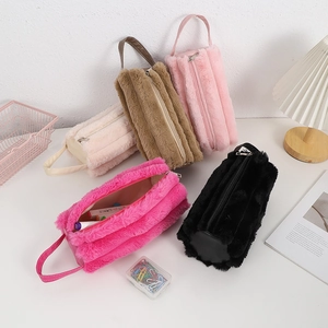 Close-up of plush cylindrical pencil cases showing soft texture and large capacity