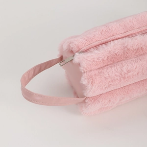 Detailed close-up of pink plush stationery bag texture and sturdy metal zipper closure