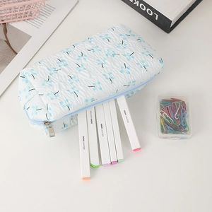 Macro shot of 3D crinkle fabric floral pencil case with zipper and blue cherry print