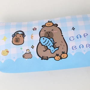 Detailed view of the blue plaid canvas fabric with cute capybara cartoon illustrations