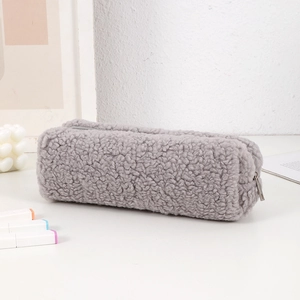 Close-up of fluffy grey plush pencil case featuring thick teddy fleece and metal zipper