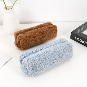 Detailed view of plush sherpa pencil cases in brown and blue with soft texture and zippers