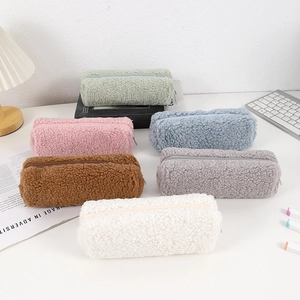 Plush teddy fleece pencil cases in six pastel colors on a cozy workspace desk