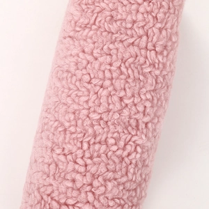 Close-up detail of soft pink thick plush lamb wool fabric texture on large pencil case