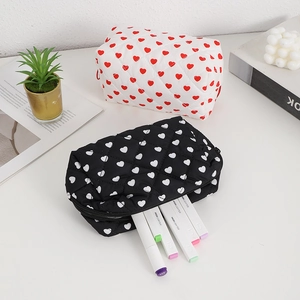 Quilted heart cosmetic bags in black and white styles with soft diamond stitching