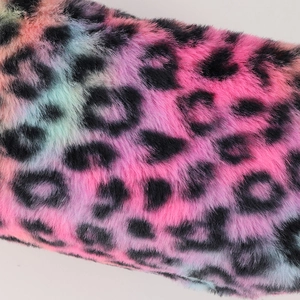 Macro shot of colorful leopard print plush fabric texture with soft faux fur details