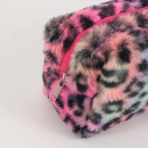 Close-up of pink leopard print faux fur makeup bag with a silver metal zipper detail
