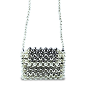 Detailed close-up of handcrafted pearl and silver beaded crossbody bag with foldover flap