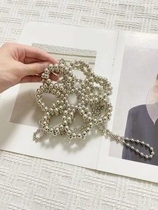 Silver beaded mini crossbody phone bag with floral hollow design and long chain strap