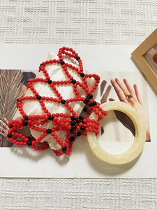 Handmade beaded handbag with red and black woven mesh and cream round resin handle
