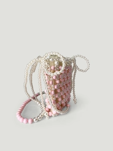 Sac à main artisanal en perles rose et blanc avec décoration de chaînes de perles