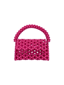 Detail of pink handmade beaded handbag featuring round pearls and woven craftsmanship