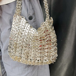 Detail of silver metallic disc chainmail handbag showing polished mirror finish and texture