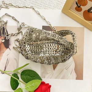 Detail of silver metallic woven chainmail handbag with unique ring link texture