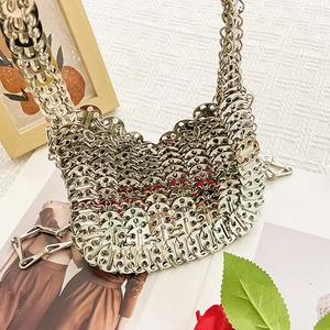 Detailed view of silver metallic disk sequins joined by rings on a stylish shoulder bag