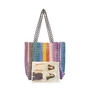 Detailed texture of handmade colorful maple wood bead woven tote bag with long handles