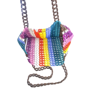 Close-up of handmade woven maple beads in a vibrant rainbow striped pattern handbag