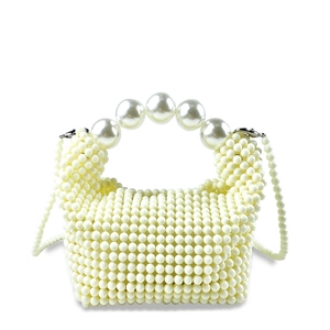 Close-up of white handmade woven pearl handbag with large bead handle and metal clasp
