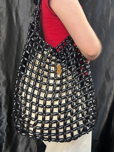 Handmade black beaded tote bag with mesh woven wood beads and golden metal clasp
