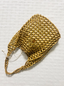 Detail of handmade woven tote bag with natural wood beads and canvas drawstring lining