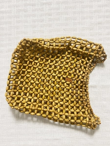 Detailed view of handmade vintage tote bag crafted with woven light brown wooden beads