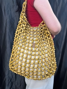 Handmade wooden bead tote bag with cream drawstring liner and woven texture detail