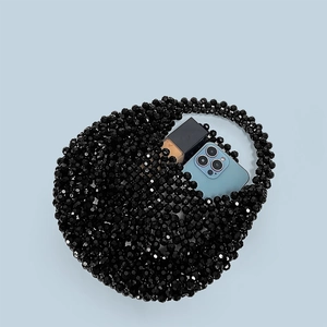 Detail view of handmade black acrylic beaded handbag showing storage capacity and beads