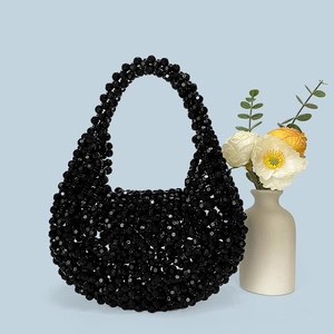 Detailed view of handmade black acrylic beaded handbag with faceted crystal-like texture