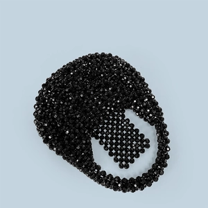 Detailed view of handmade black acrylic beaded handbag with faceted geometric surface