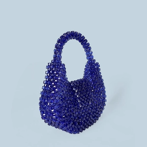 Close-up of deep blue handmade acrylic beaded handbag with faceted crystal texture