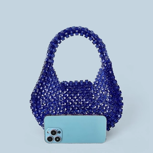 Detailed macro view of handmade dark blue acrylic beaded handbag with shiny faceted beads