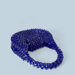Macro detail of dark blue hobo bead bag featuring handcrafted faceted acrylic textures