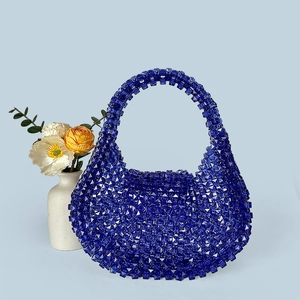 Detail of royal blue acrylic beaded handbag showing intricate clear crystal texture