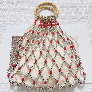 Detail of woven bead bag with bamboo handles and drawstring cotton inner pouch